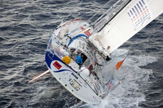 BILBAO, SPAIN - October 22nd 2006: Kojiro Shiraishi (JPN) onboard his Open 60ft monohull SPIRIT OF YUKOH during Leg 1 of the Velux 5 Oceans yacht race. The Velux 5 Oceans is a three part round the world yacht race for the bravest of solo sailors. Leg 1 is approximately 12,000 miles from Bilbao in Spain to Fremantle in Western Australia. It is the ultimate test of sailing skill, stamina and endurance. (Rights restrictions may apply)