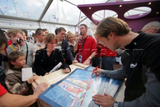 ST. MALO, FRANCE - OCTOBER 27th 2006: Thomas Colville (Fr) skipper of Sodebo signs photographs of his yacht on October 27th and 28th before the trans-atlantic race start on Sunday October 29th 2006. The Route du Rhum is a challenging race for solo sailors which starts in St Malo and finishes in Pointe a Pitre, Guadeloupe.