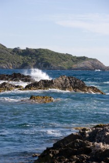 The sea plays over rocks on a sunny day