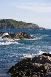 The sea plays over rocks on a sunny day