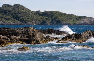 The sea plays over rocks on a sunny day