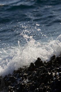 Close up of a wave breaking over the rocks