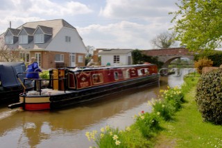 Narrow boat passing moorings on Llangollen canal near Frankton Junction,Welsh Frankton,Shropshire,England,UK.