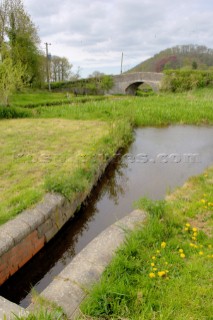 By-wash above Brithdir locks,Montgomery Canal,with bridge 125 in the background,near Berriew,Powys,Wales,UK.May 2006.