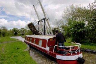 Narrow boat approaching Allmans lift bridge No.1,Prees branch,Llangollen canal,near Whixall,Shropshire,England,UK.May 2006.