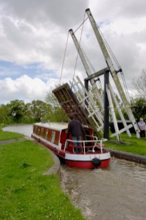 Narrow boat passing through Allmans lift bridge No.1,Prees branch,Llangollen canal,near Whixall,Shropshire,England,UK.May 2006.