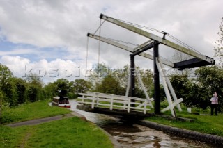 Narrow boat passing through Allmans lift bridge No.1,Prees branch,Llangollen canal,near Whixall,Shropshire,England,UK.May 2006.