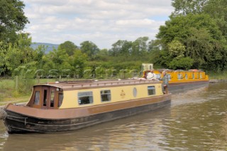 Women on narrow boat approaching the Jack Mytton Inn on the Llangollen canal,near Hindford,Whittington,Shropshire,England.June 2006.