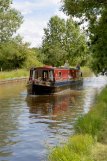 Man and woman on narrowboat approaching New Marton bottom lock,Llangollen canal,New Marton,Shropshire,England.June 2006.