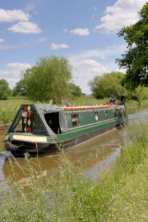 Man and woman on narrowboat approaching New Marton bottom lock,Llangollen canal,New Marton,Shropshire,England.June 2006.