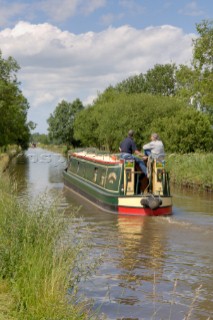 Man and woman on narrowboat approaching New Marton bottom lock,Llangollen canal,New Marton,Shropshire,England.June 2006.