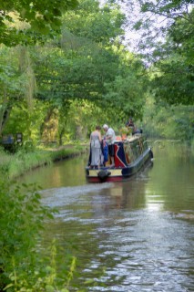 Man and woman on narrowboat having just exited Ellesmere tunnel,Llangollen canal,Ellesmere,Shropshire,England.July 2006.