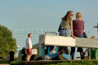 Women sat on the lock gate at Wheaton Aston lock on the Shropshire Union canal,Staffordshire,England,September 2006.