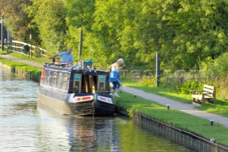 Couple mooring narrow boat below Wheaton Aston lock,Shropshire Union canal,Staffordshire,England,September 2006.