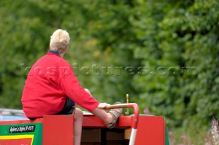 Woman driving narrow boat on the Llangollen canal at Bettisfield,Clwyd,Wales,August 2006.