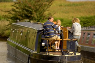 Family on narrow boat on the Llangollen canal at Bettisfield,Clwyd,Wales,August 2006.