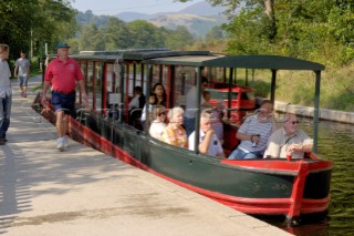 Visitors on the trip boat on the Llangollen canal at Llangollen wharf,Clwyd,Wales,September 2006.