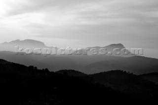 Silhouette and shadows of rolling hills in a misty light