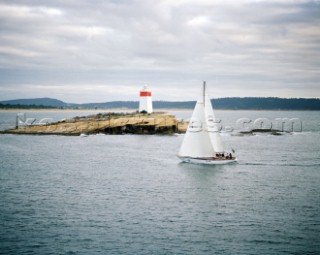 Love and War passing the Iron Pot approaching Tasmania and the finish if the Rolex Sydney Hobart Race 2006 to win on handicap