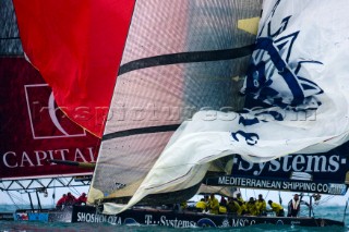 Americas Cup yachts drop spinnakers at the leeward mark