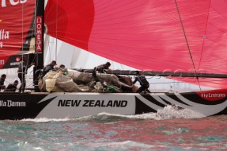 bowmen Richard Meacham crew stow the genoa after NZL84 round the top mark in on the final leg of race one of the Louis Vuitton Act 13. 3/4/2007