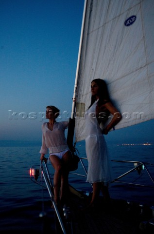 Glamorous female lifestyle model onboard a sailing yacht in the Mediterranean