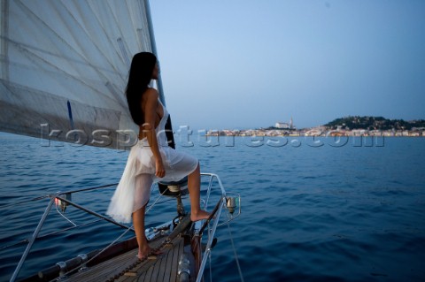 Glamorous female lifestyle model onboard a sailing yacht in the Mediterranean