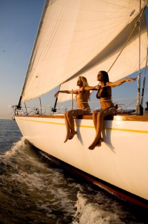 Glamorous female lifestyle model onboard a sailing yacht in the Mediterranean