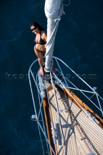 Glamorous female lifestyle model onboard a sailing yacht in the Mediterranean