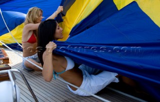 Glamorous female lifestyle model onboard a sailing yacht in the Mediterranean