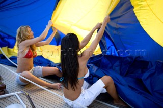 Glamorous female lifestyle model onboard a sailing yacht in the Mediterranean