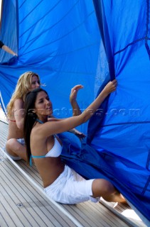 Glamorous female lifestyle model onboard a sailing yacht in the Mediterranean