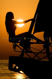 Glamorous female lifestyle model onboard a sailing yacht in the Mediterranean