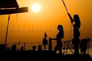 Glamorous female lifestyle model onboard a sailing yacht in the Mediterranean