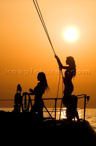 Glamorous female lifestyle model onboard a sailing yacht in the Mediterranean