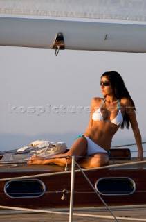 Glamorous female lifestyle model onboard a sailing yacht in the Mediterranean