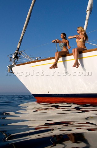 Glamorous female lifestyle model onboard a sailing yacht in the Mediterranean