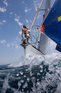 Glamorous female lifestyle model onboard a sailing yacht in the Mediterranean