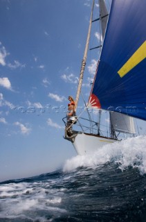 Glamorous female lifestyle model onboard a sailing yacht in the Mediterranean