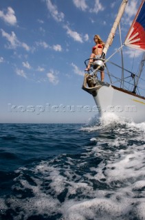 Glamorous female lifestyle model onboard a sailing yacht in the Mediterranean