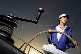 Glamorous female lifestyle model onboard a sailing yacht in the Mediterranean