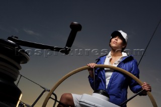 Glamorous female lifestyle model onboard a sailing yacht in the Mediterranean