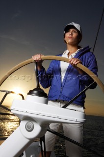 Glamorous female lifestyle model onboard a sailing yacht in the Mediterranean