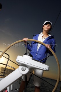 Glamorous female lifestyle model onboard a sailing yacht in the Mediterranean