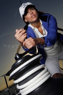 Glamorous female lifestyle model onboard a sailing yacht in the Mediterranean