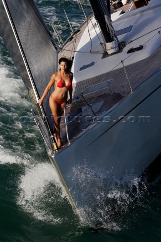 Glamorous female lifestyle model onboard a sailing yacht in the Mediterranean