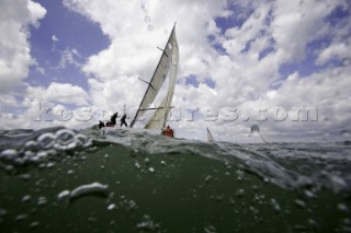 Above and below the water surface as a yacht rounds the windward mark on Day 5 of the Rolex Commodores Cup 2008 in the Solent, UK.