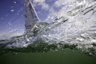 Above and below the water surface as a yacht rounds the windward mark on Day 5 of the Rolex Commodores Cup 2008 in the Solent, UK.