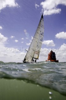 Above and below the water surface as a yacht rounds the windward mark on Day 5 of the Rolex Commodores Cup 2008 in the Solent, UK.