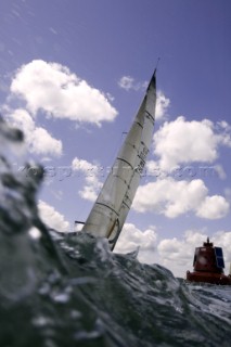 Above and below the water surface as a yacht rounds the windward mark on Day 5 of the Rolex Commodores Cup 2008 in the Solent, UK.